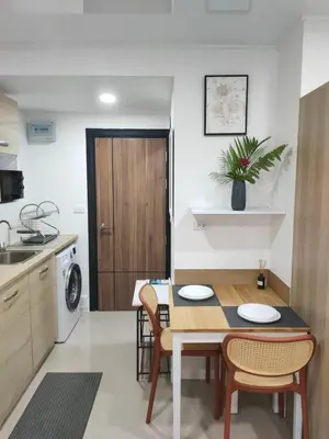 a kitchen and dining room with a table and chairs at 777 Condo Phuket in Ban Mai Salae