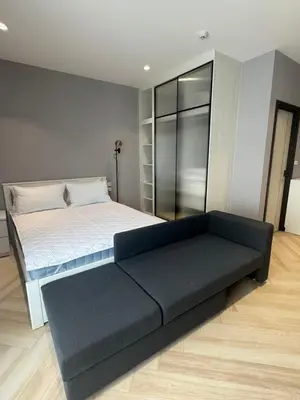 a bedroom with a large bed and a couch at Квартира в Legendary Bang Tao in Bang Tao Beach