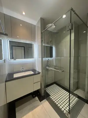 a bathroom with a glass shower and a sink at Квартира в Legendary Bang Tao in Bang Tao Beach
