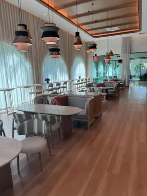 a restaurant with tables and chairs in a room at Квартира в Legendary Bang Tao in Bang Tao Beach