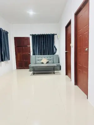 a living room with a couch and two doors at SINTO Homestay Yao Noi in Ko Yao Noi