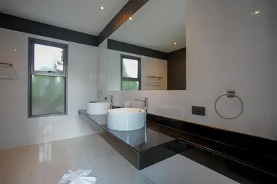 a bathroom with two sinks and a large mirror at Villa Tropicana - Luxury 4 Bedroom Villa in Rawai Beach