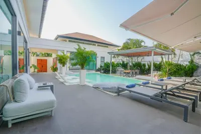 a house with a swimming pool and a patio at Villa Tropicana - Luxury 4 Bedroom Villa in Rawai Beach