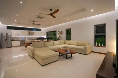 a living room with a couch and a table at Villa Tropicana - Luxury 4 Bedroom Villa in Rawai Beach