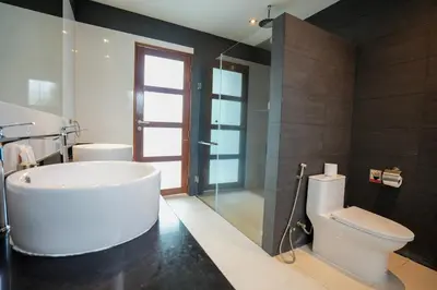 a bathroom with a white tub and a toilet at Villa Tropicana - Luxury 4 Bedroom Villa in Rawai Beach