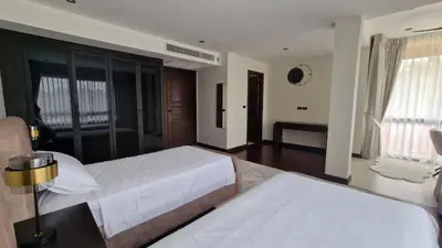 a large bedroom with two beds and a couch at Desiner Villa in Laguna Village, Bang Tao Beach, Phuket in Layan Beach
