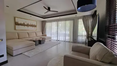 a living room with a couch and a tv at Desiner Villa in Laguna Village, Bang Tao Beach, Phuket in Layan Beach