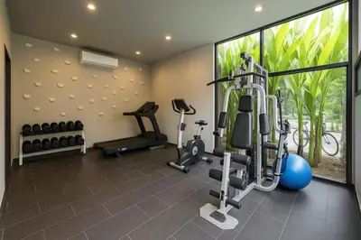a gym with treadmills and exercise equipment in a house at VILLA Miriama 2 Bedroom Near Naiharn Beach in Rawai Beach