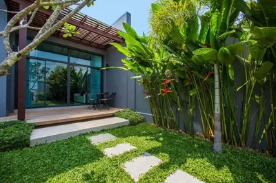 a house with a garden and a patio at VILLA Miriama 2 Bedroom Near Naiharn Beach in Rawai Beach