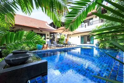 a swimming pool in front of a villa at Baan Bua Estate Villas by TropicLook in Nai Harn Beach