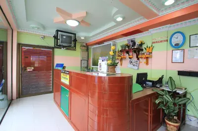 a restaurant with a counter and a tv on the wall at Baan Boa Guest House in Patong Beach