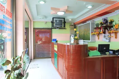 a restaurant with a counter and a tv on the ceiling at Baan Boa Guest House in Patong Beach