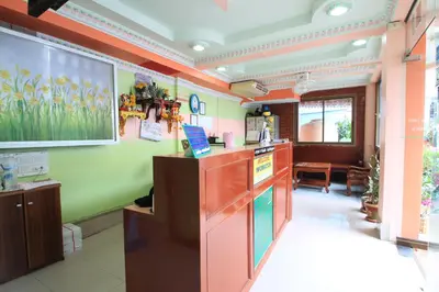 a kitchen with green and orange walls and a counter at Baan Boa Guest House in Patong Beach