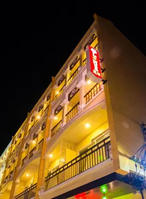 a building with a sign on the side of it at Le Hua Hotel in Phuket Town