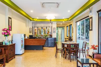 a kitchen and dining room with a table and chairs at Le Hua Hotel in Phuket Town