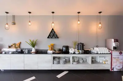 a kitchen with a counter with pots and pans at Maya Phuket Airport Hotel-Naiyang Beach in Nai Yang Beach