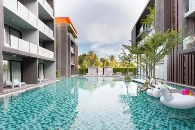 an infinity pool with swans in the middle of a building at Maya Phuket Airport Hotel-Naiyang Beach in Nai Yang Beach