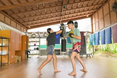 two young men in a gym with a punching bag at TheLifeCo Phuket - Holistic Wellbeing Center in Nai Thon Beach