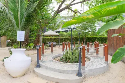 a garden with a large vase and a planter at TheLifeCo Phuket - Holistic Wellbeing Center in Nai Thon Beach