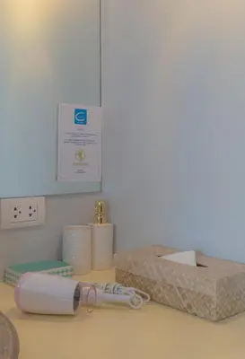 a counter with toilet paper and a pair of glasses at TheLifeCo Phuket - Holistic Wellbeing Center in Nai Thon Beach