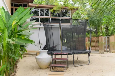 a chair sitting in front of a gazebo at TheLifeCo Phuket - Holistic Wellbeing Center in Nai Thon Beach