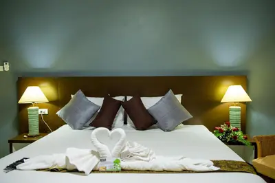 a bedroom with a bed with two towels on it at Z-Talay House in Klong Muang Beach