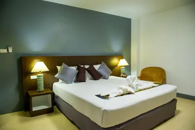 a bedroom with a large bed with white sheets and pillows at Z-Talay House in Klong Muang Beach