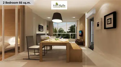 a living room with a dining room table and a bedroom at Hill Myna Condotel Official Account in Bang Tao Beach