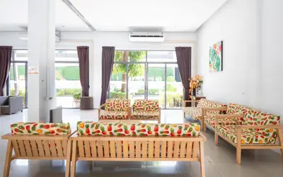 a living room with benches with apples on them at Patong Bay Hill in Patong Beach