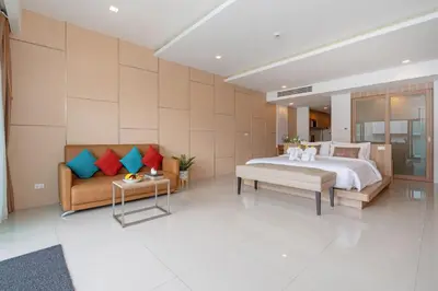 a bedroom with a bed and a couch at Patong Bay Hill in Patong Beach