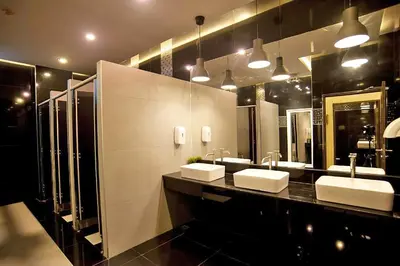 a bathroom with two sinks and two mirrors at The Gig Hotel in Patong Beach