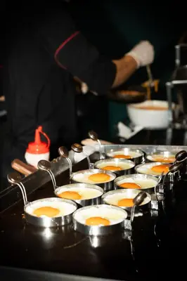 a bunch of eggs are cooking in a pan at The Gig Hotel in Patong Beach