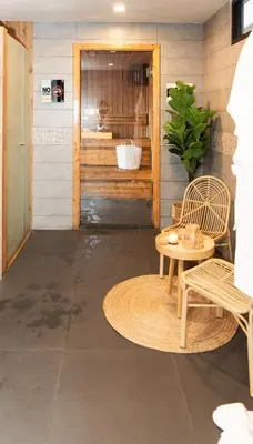a room with two chairs and a table and a door at The Gig Hotel in Patong Beach