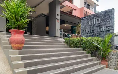a set of concrete stairs with a red vase at The Gig Hotel in Patong Beach