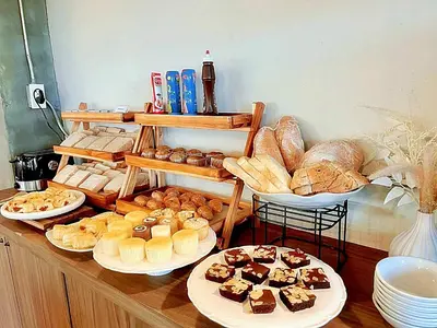 a table with different types of bread and pastries at The Sixteenth Naiyang Beach Hotel- Free Schedule Airport Shuttle in Nai Yang Beach