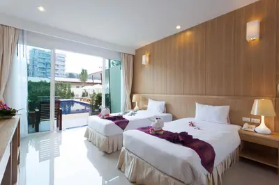 a hotel room with two beds and a balcony at Chalong Princess Pool Villa Resort SHA EXTRA PLUS in Chalong