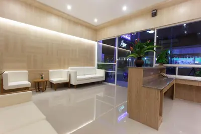 a lobby with white furniture and a large window at Chalong Princess Pool Villa Resort SHA EXTRA PLUS in Chalong