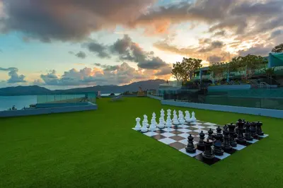 a chess board on a field with a sunset at Crest Resort & Pool Villas - SHA Extra Plus in Patong Beach