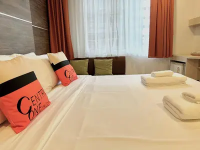 a large white bed with two pillows on it at Centro One Bangla in Patong Beach