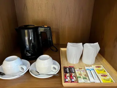 a table with two cups and a coffee maker at Centro One Bangla in Patong Beach
