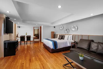 a hotel room with a bed and a couch at Luxury 4 pool Seaview 6 bedroom Villa on Surin Hill in Surin Beach