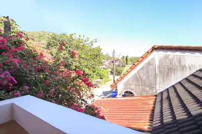 a view of a house with flowers on a roof at Ban Elephant Blanc Apartment in Kata Beach