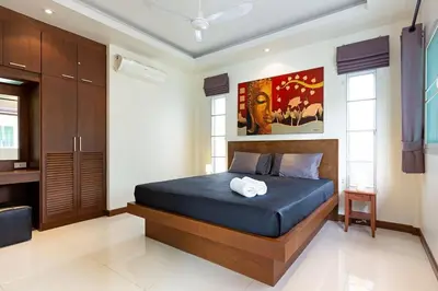 a bedroom with a large blue bed in a room at Residence Harmonie in Rawai Beach