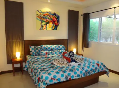 a bedroom with a bed with a stuffed animal on it at Residence Harmonie in Rawai Beach