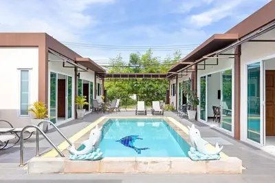 a swimming pool with two polar bears in a house at Residence Harmonie in Rawai Beach