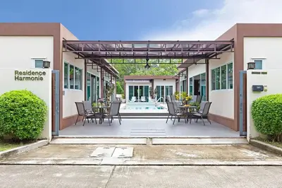 a patio with a table and chairs in a building at Residence Harmonie in Rawai Beach