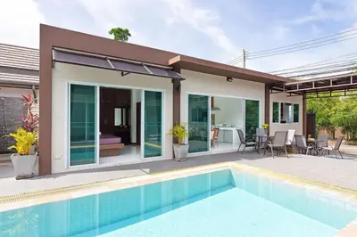 a villa with a swimming pool and a house at Residence Harmonie in Rawai Beach