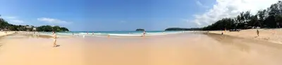 a beach with a lot of sand and the ocean at Apartments in The Title Beach Rawai in Rawai Beach