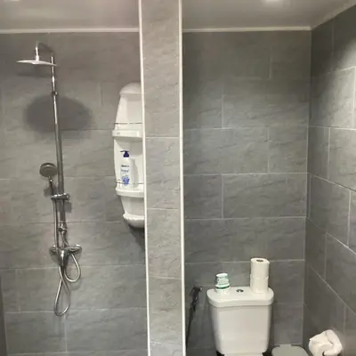 a bathroom with a toilet and a shower stall at Bann Jai Dee in Nai Yang Beach