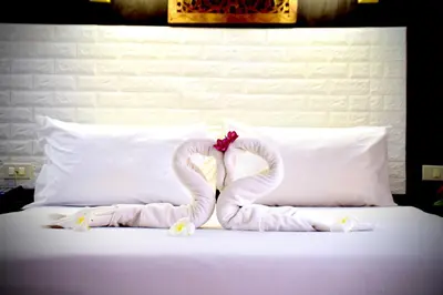 a bed with two swans made out of towels at Wan Wan Place in Ao Nang Beach
